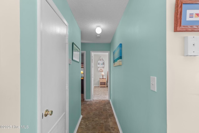 hallway with a textured ceiling