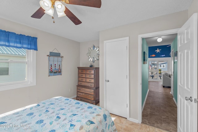 tiled bedroom with ceiling fan