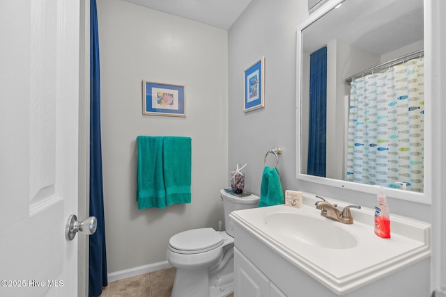 bathroom featuring vanity, tile patterned floors, and toilet