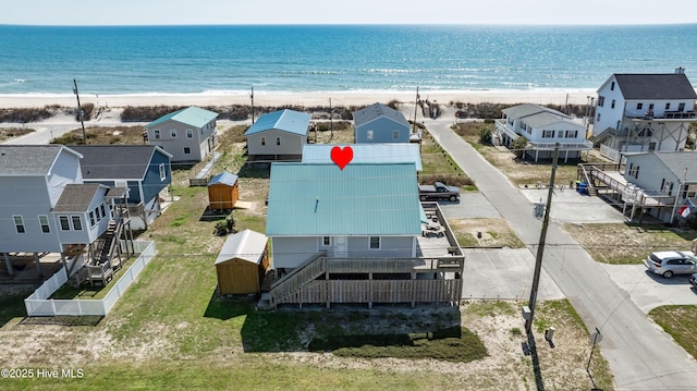 bird's eye view featuring a water view and a beach view