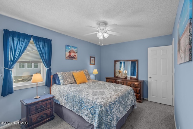 carpeted bedroom featuring ceiling fan and a textured ceiling