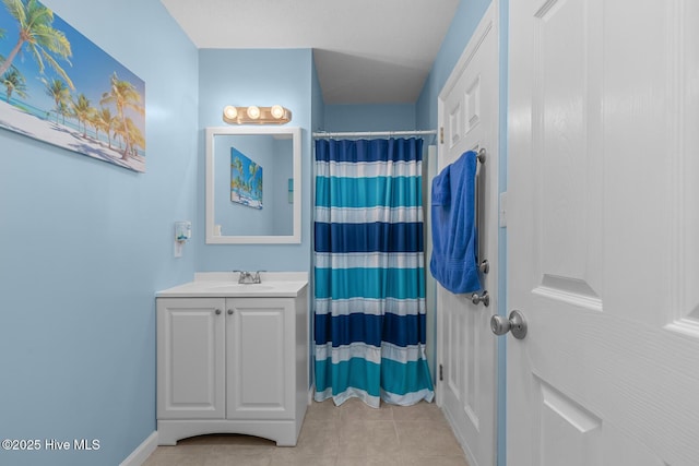 bathroom with a shower with shower curtain, vanity, and tile patterned flooring