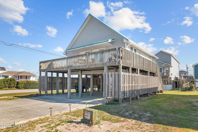 rear view of property featuring a yard and a carport