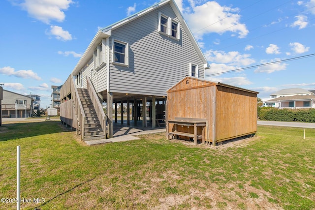 rear view of property with a storage shed and a lawn