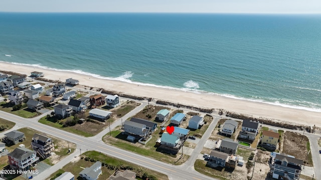 drone / aerial view featuring a water view and a view of the beach