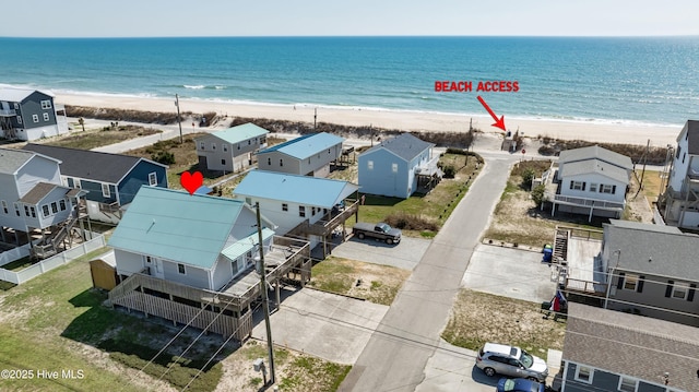 drone / aerial view featuring a view of the beach and a water view