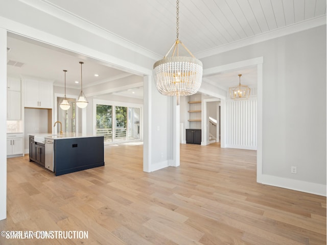 unfurnished dining area featuring crown molding, light wood-type flooring, baseboards, and a notable chandelier