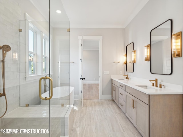 full bath featuring a soaking tub, a sink, a tile shower, and double vanity