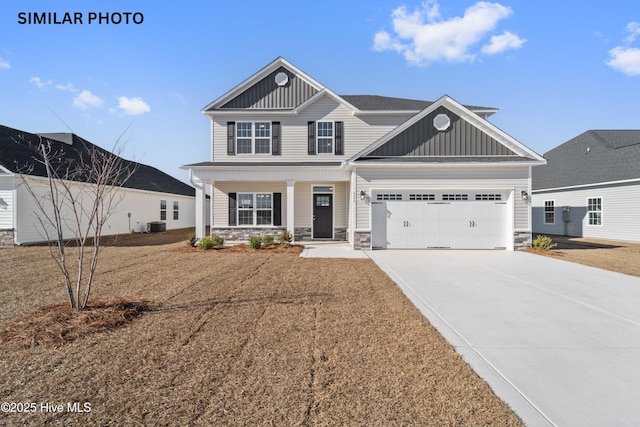 view of front of home featuring a garage, a porch, and cooling unit