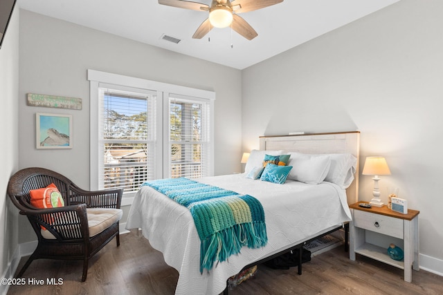 bedroom with visible vents, baseboards, ceiling fan, and wood finished floors