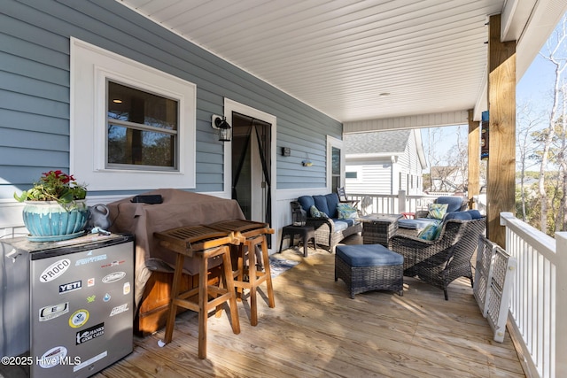 wooden terrace featuring outdoor lounge area