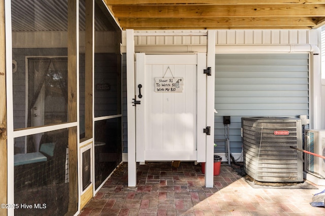 view of exterior entry featuring central AC