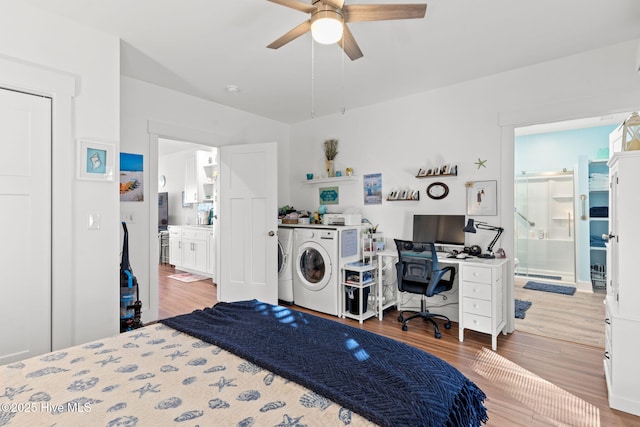 bedroom with ceiling fan, ensuite bath, washing machine and clothes dryer, and wood finished floors