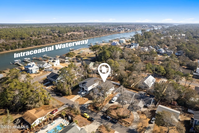 drone / aerial view featuring a water view and a view of trees