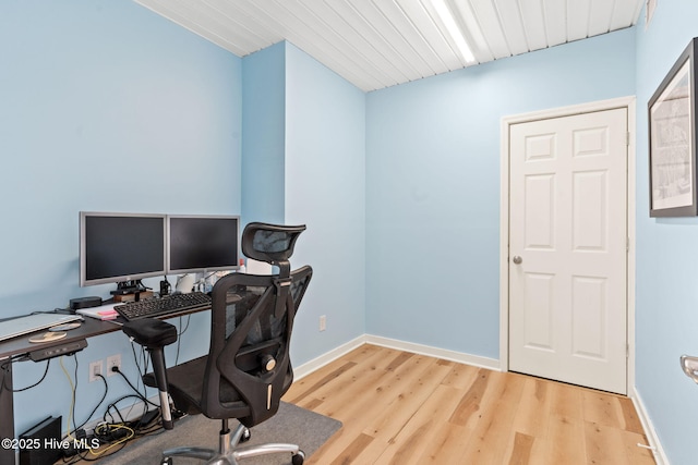 office featuring light wood finished floors, wooden ceiling, and baseboards