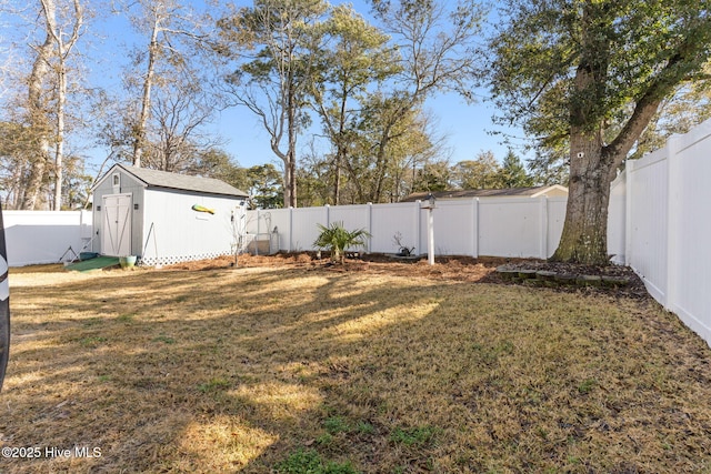 view of yard featuring an outbuilding, a shed, and a fenced backyard