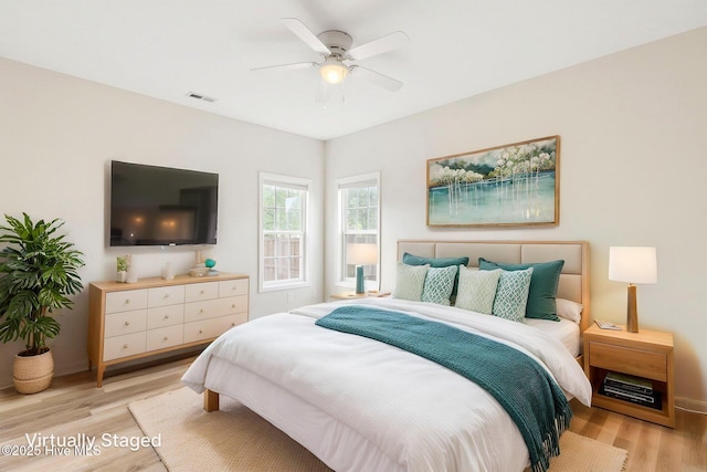 1010 Winterberry Cir, Leland, NC 28451 - bedroom featuring light wood-type flooring, a ceiling fan, and baseboards
