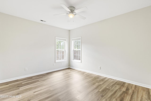 1010 Winterberry Cir, Leland, NC 28451 - empty room featuring a ceiling fan, light wood-style flooring, and baseboards