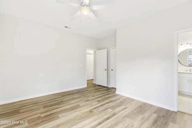 1010 Winterberry Cir, Leland, NC 28451 - unfurnished bedroom with light wood-style flooring, ensuite bathroom, baseboards, and ceiling fan