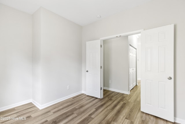 1010 Winterberry Cir, Leland, NC 28451 - unfurnished bedroom with light wood-type flooring and baseboards