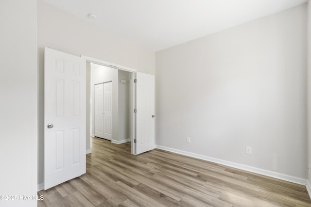 1010 Winterberry Cir, Leland, NC 28451 - unfurnished bedroom with light wood-style flooring and baseboards