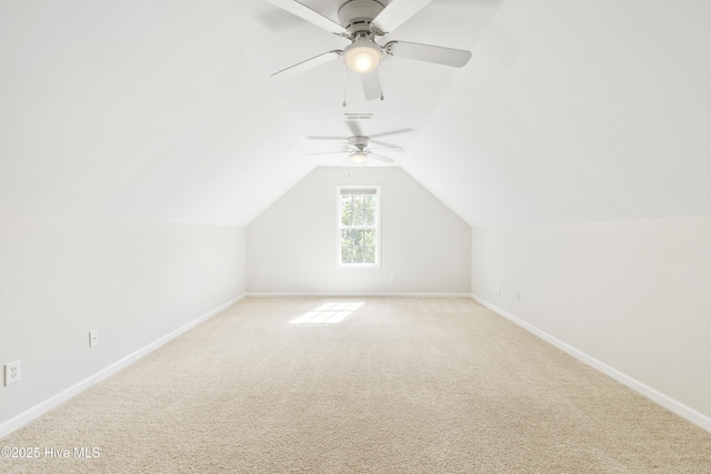 additional living space with baseboards, ceiling fan, and light carpet