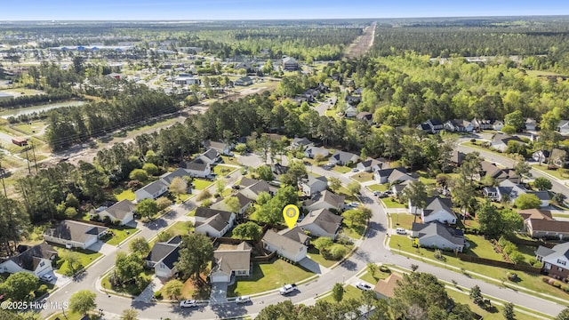 birds eye view of property featuring a residential view and a forest view