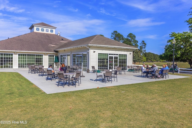 1010 Winterberry Cir, Leland, NC 28451 - rear view of house with a yard, a shingled roof, and a patio area