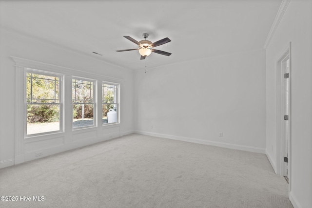 spare room featuring a ceiling fan, light carpet, visible vents, and baseboards