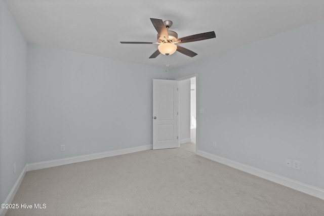 unfurnished room featuring carpet, baseboards, and a ceiling fan