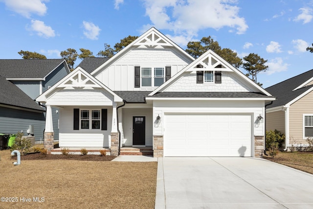 craftsman house with concrete driveway, board and batten siding, stone siding, and roof with shingles