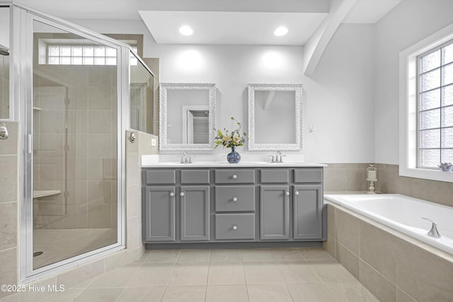 bathroom featuring vanity, shower with separate bathtub, and a healthy amount of sunlight