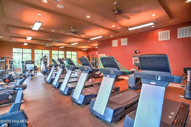 workout area featuring a tray ceiling