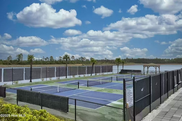 view of tennis court with a water view