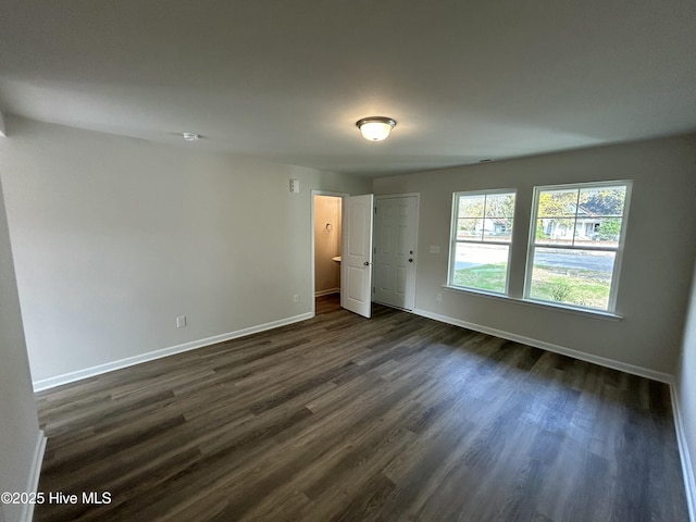 unfurnished bedroom with dark hardwood / wood-style floors