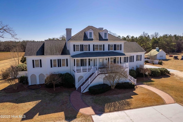 view of front of property with a front yard and a porch