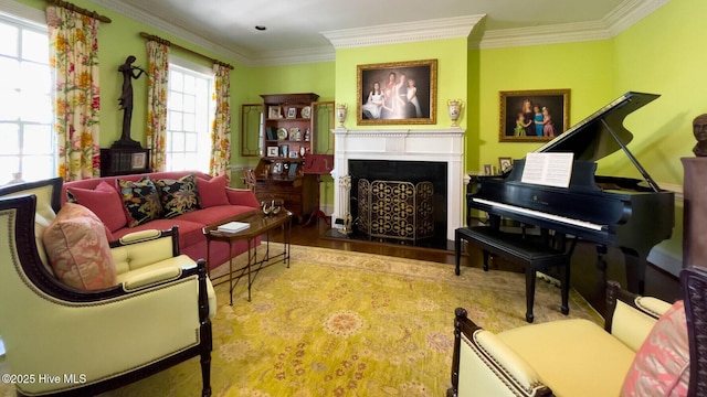 living area with crown molding and hardwood / wood-style floors