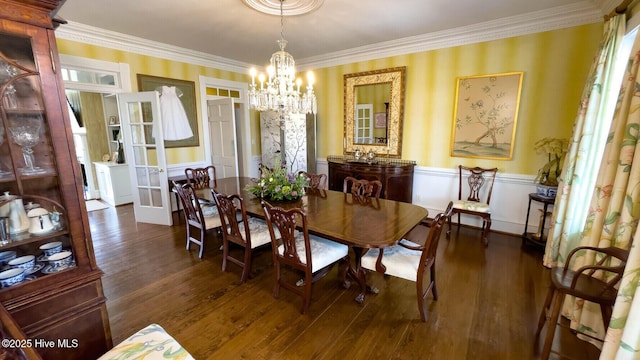 dining area with a notable chandelier, crown molding, dark wood-type flooring, and french doors