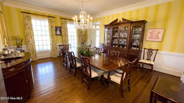 dining area with crown molding, an inviting chandelier, and dark hardwood / wood-style flooring