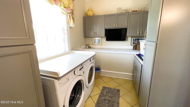 laundry room with separate washer and dryer and light tile patterned floors