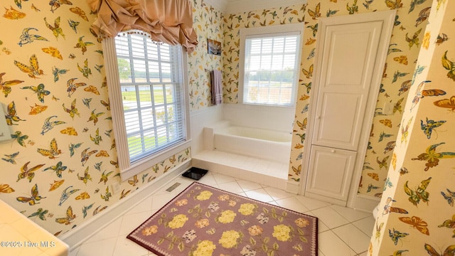 bathroom with plenty of natural light, tile patterned floors, and a bathing tub