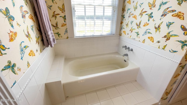 bathroom featuring tile patterned flooring and a tub to relax in