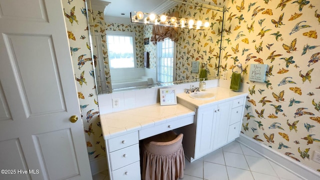 bathroom featuring vanity, a tub, tile patterned floors, and crown molding