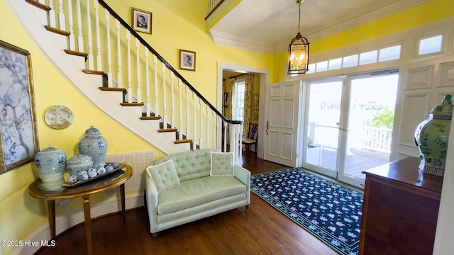 entrance foyer with ornamental molding and dark hardwood / wood-style flooring