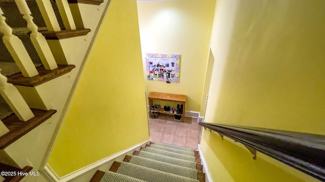 stairway with tile patterned floors