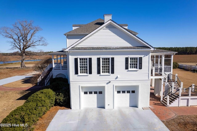 view of home's exterior featuring a garage and a sunroom