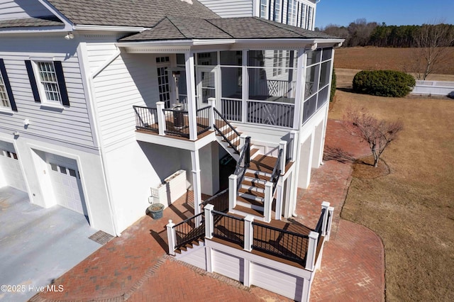 exterior space featuring a garage and a sunroom