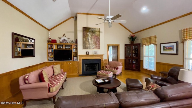 living room with crown molding, ceiling fan, wooden walls, and high vaulted ceiling