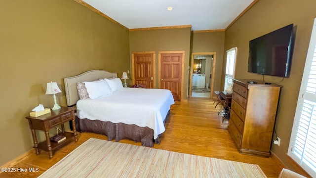 bedroom with multiple windows, ornamental molding, and light hardwood / wood-style flooring