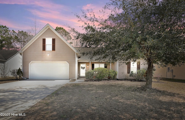 view of front of property with a garage, a front yard, and driveway